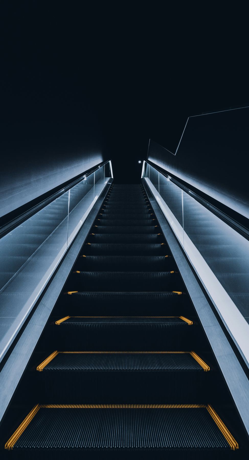 Illuminated escalator in a commercial building at night